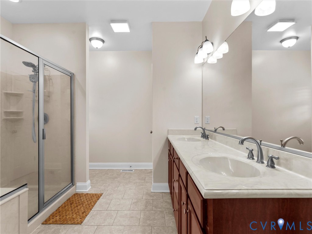 1555 Rocky Ford Road Powhatan, VA 23139 - Photo 31 of 80 a bathroom with a sink a mirror and a shower