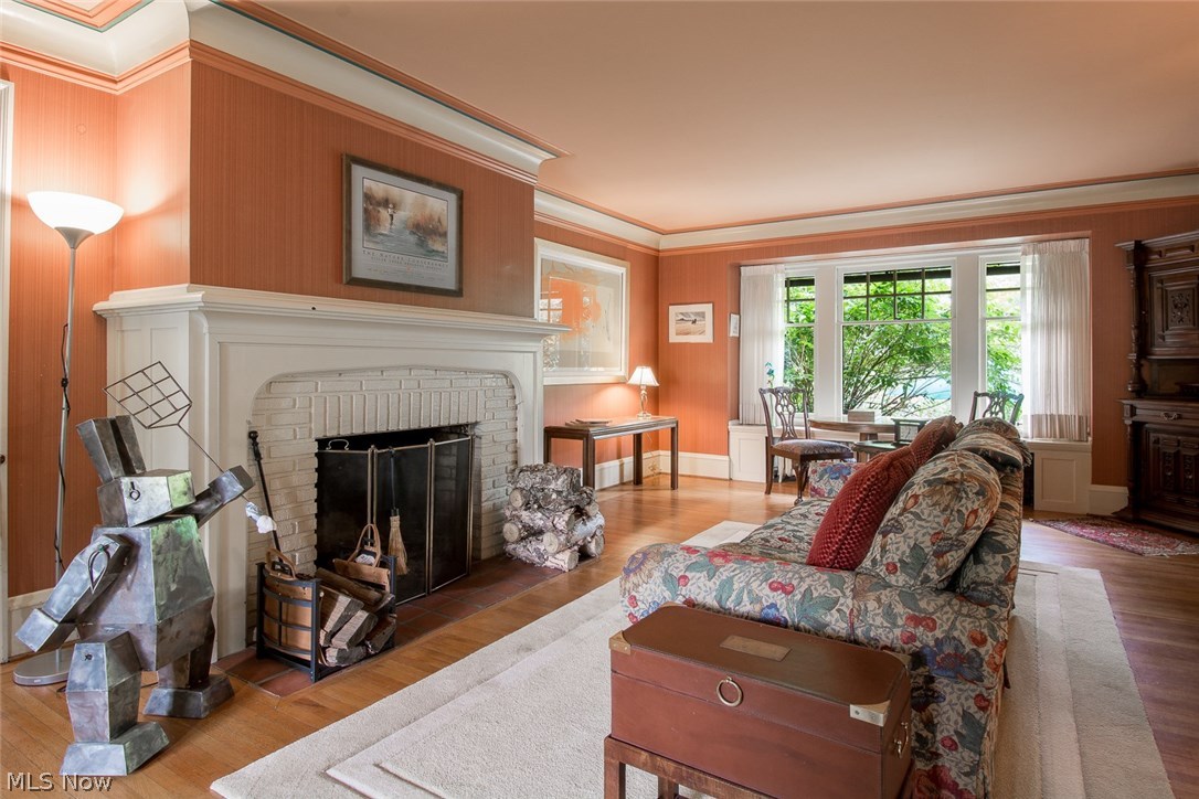 2595 Norfolk Road Cleveland, OH 44106 - Photo 10 of 19 Spacious Living Room features a wood burning fireplace and large window overlooking backyard garden