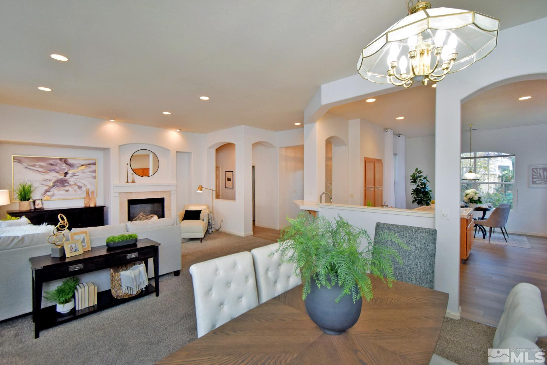 9673 Shadowstone Way Reno, NV 89521 - Photo 9 of 31 a living room with fireplace furniture and a chandelier