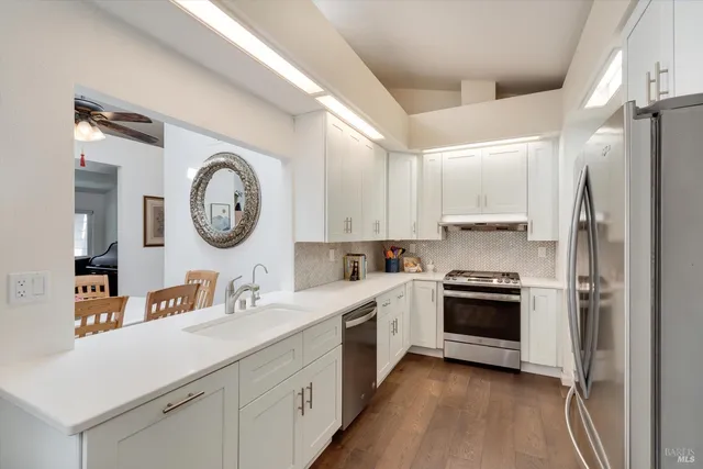 a kitchen with a stove a sink and a refrigerator
