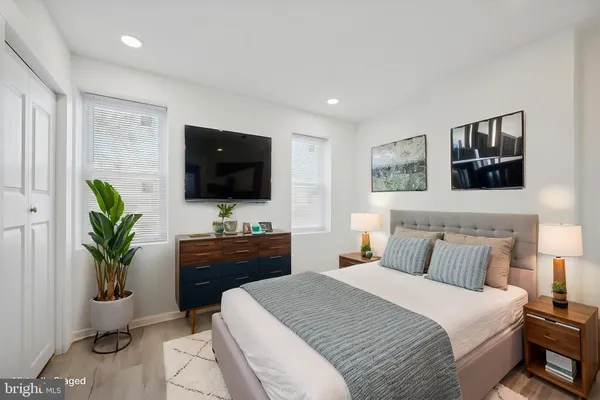 a bedroom with a bed and a flat screen tv