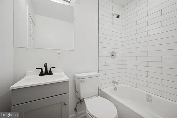 a bathroom with a sink a toilet and bathtub