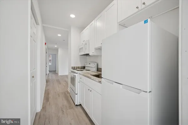 a kitchen with stainless steel appliances a refrigerator sink and stove
