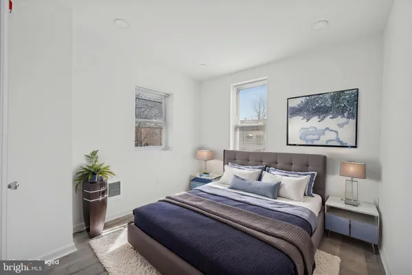 a bedroom with a bed and a painting on the wall