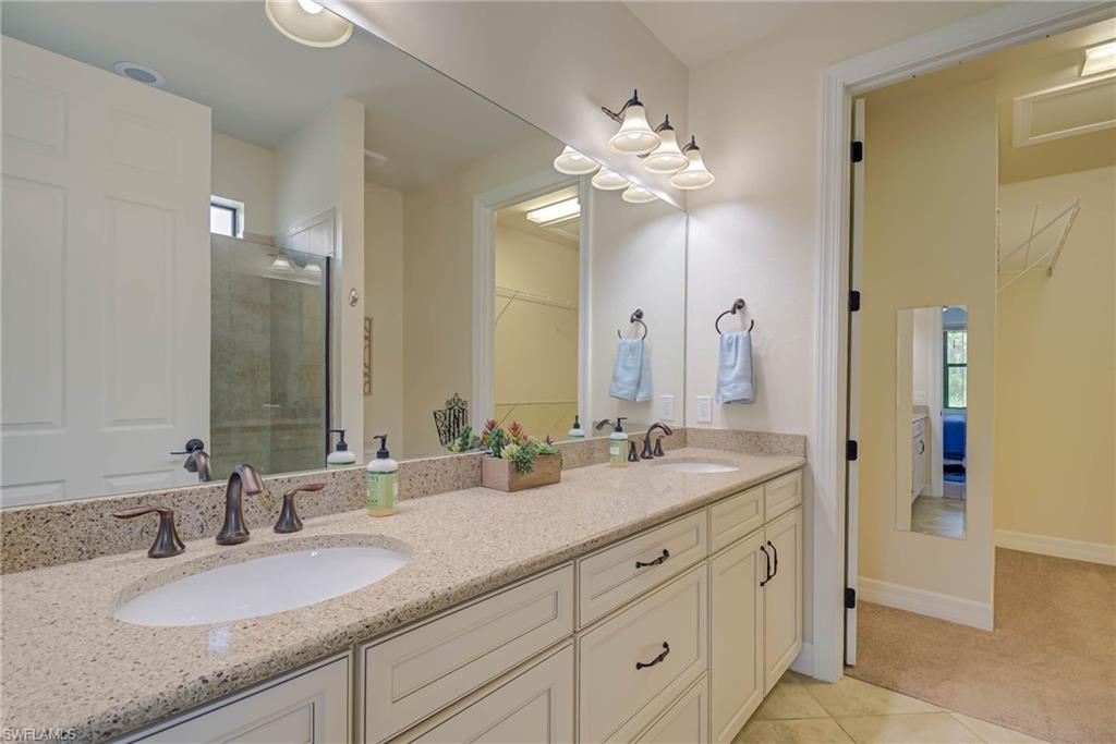 5761 Mayflower Way Ave Maria, FL 34142 - Photo 17 of 39 a bathroom with a granite countertop double vanity sink mirror and