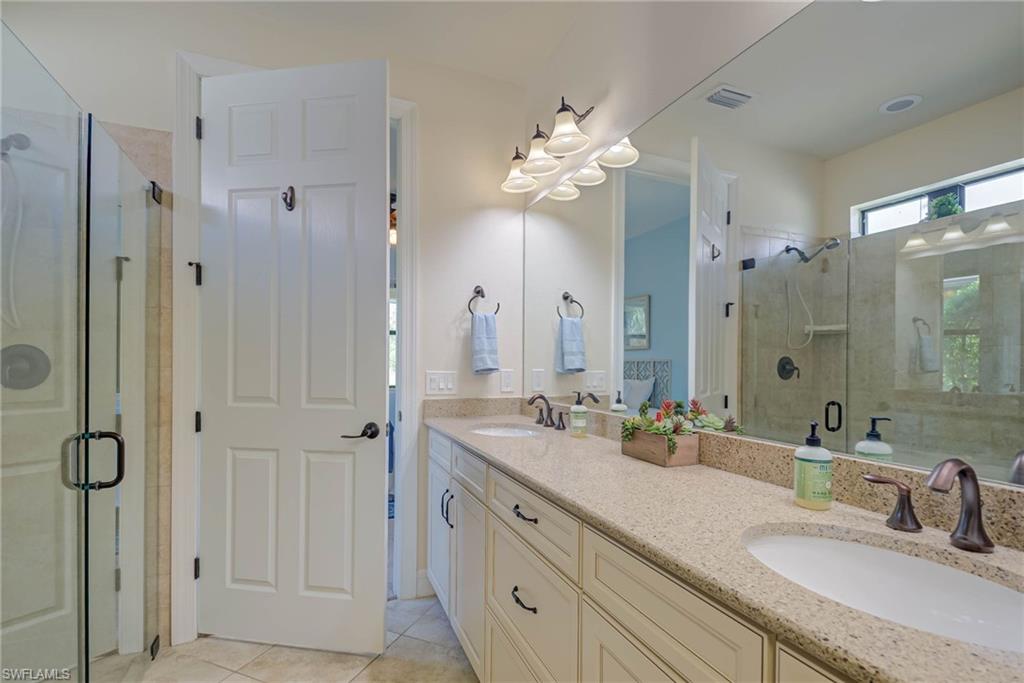 5761 Mayflower Way Ave Maria, FL 34142 - Photo 18 of 39 a bathroom with a double vanity sink mirror and shower