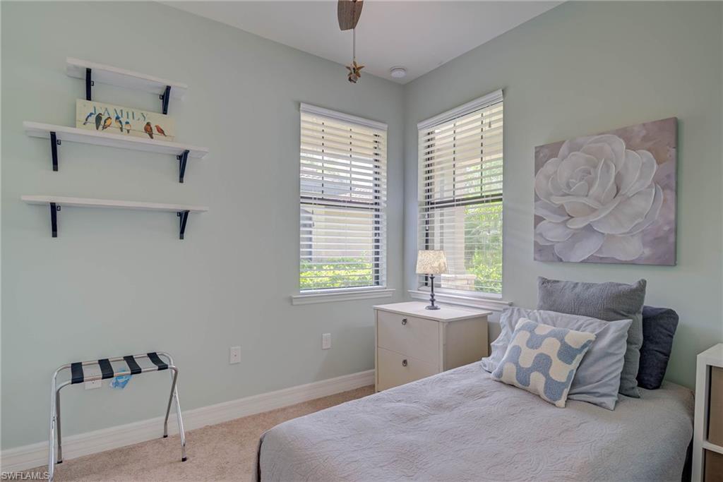 5761 Mayflower Way Ave Maria, FL 34142 - Photo 21 of 39 a bedroom with a bed and a window