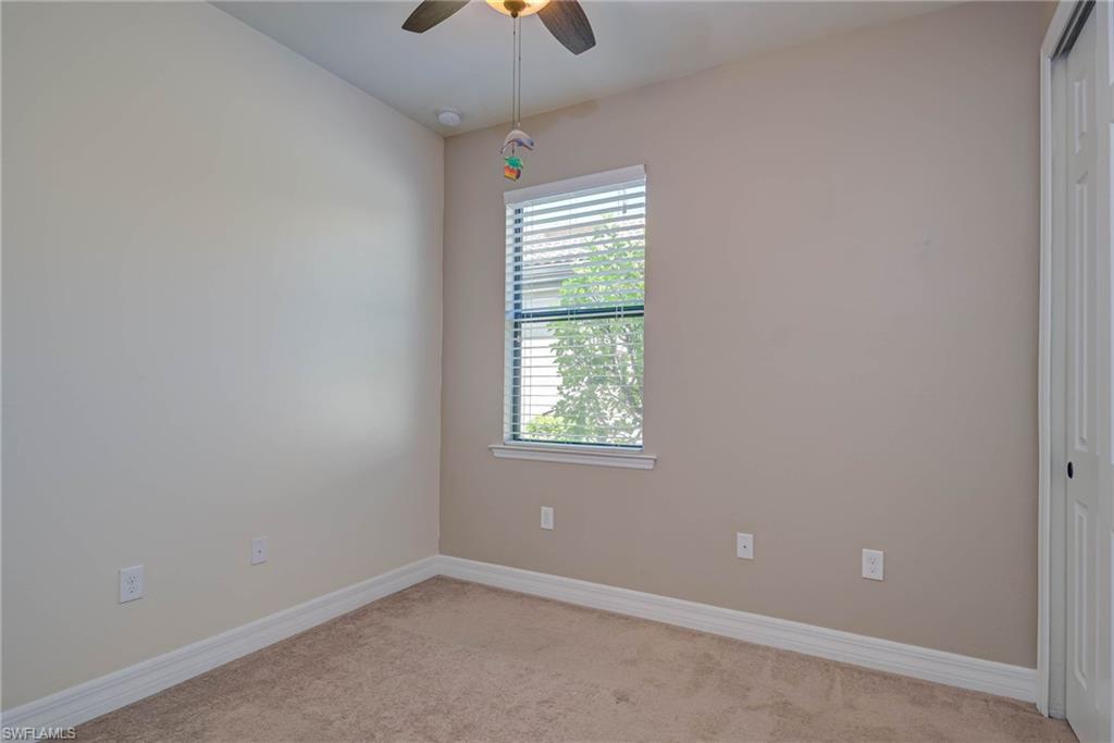 5761 Mayflower Way Ave Maria, FL 34142 - Photo 23 of 39 an empty room with windows and fan