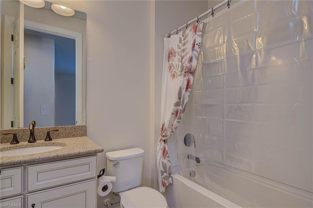5761 Mayflower Way Ave Maria, FL 34142 - Photo 25 of 39 a bathroom with a granite countertop sink a toilet and shower