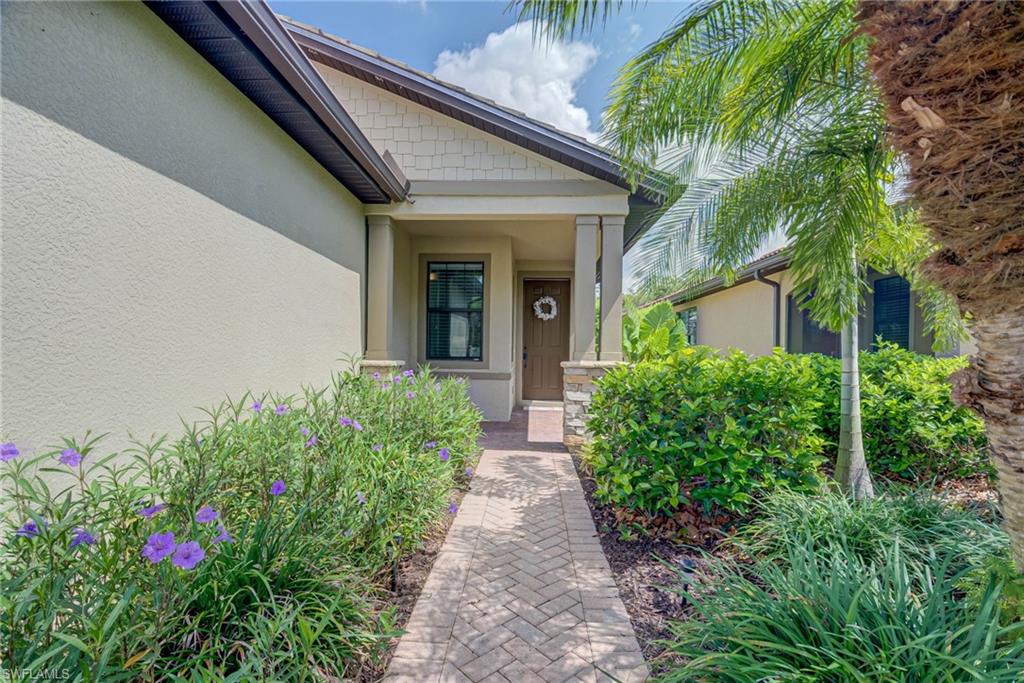 5761 Mayflower Way Ave Maria, FL 34142 - Photo 30 of 39 a view of a pathway with house and garden
