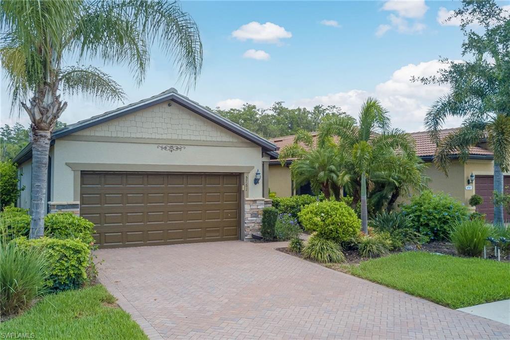 5761 Mayflower Way Ave Maria, FL 34142 - Photo 31 of 39 a front view of a house with a yard and garage