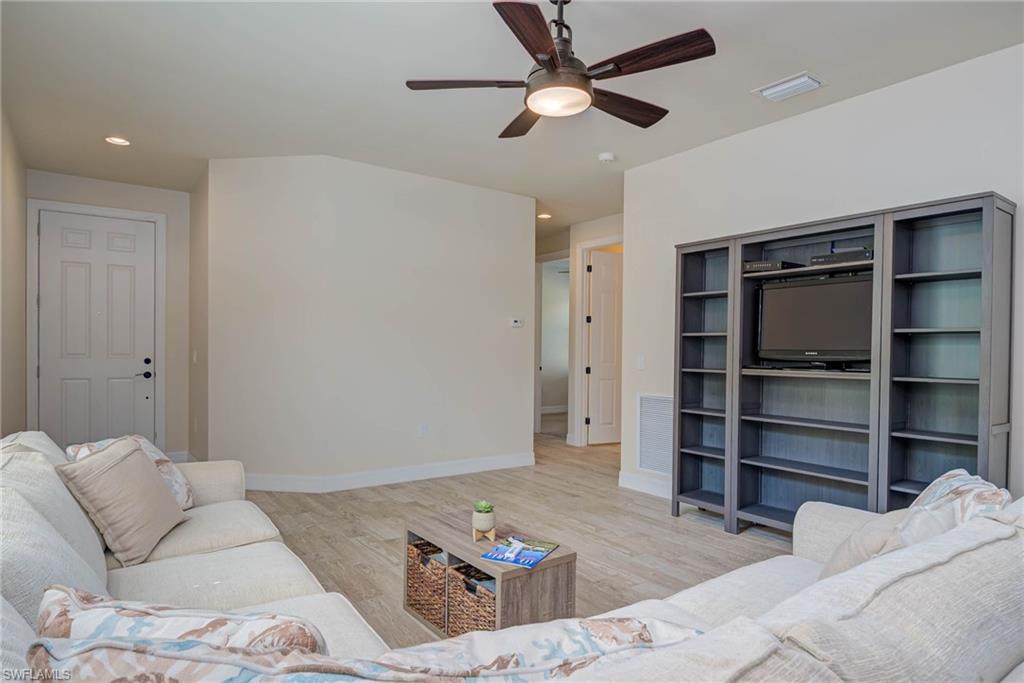 5761 Mayflower Way Ave Maria, FL 34142 - Photo 6 of 39 a living room with furniture and a ceiling fan