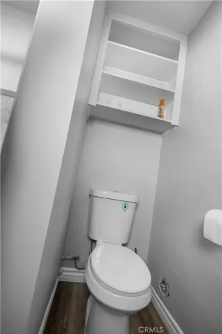 a white toilet sitting next to a shower