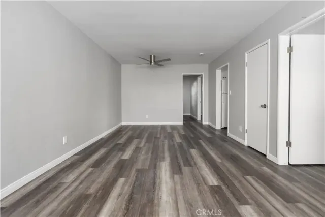 a view of a room with wooden floor and white walls