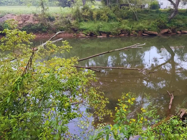 a view of a lake with a house in the background