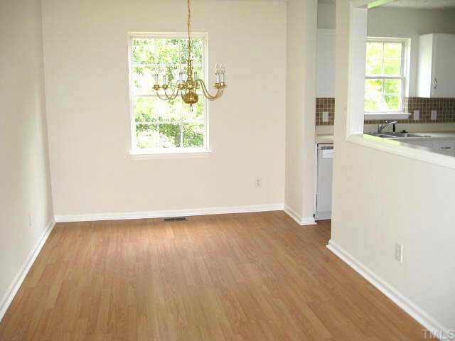 2305 Springhill Avenue Raleigh, NC 27603 - Photo 3 of 10 an empty room with wooden floor and windows