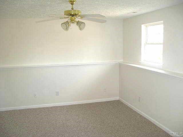 2305 Springhill Avenue Raleigh, NC 27603 - Photo 5 of 10 an empty room with a window