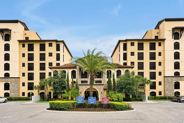 a front view of a building with a garden