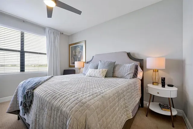 a bedroom with a bed and a lamp