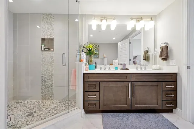 a bathroom with a sink vanity granite and a mirror