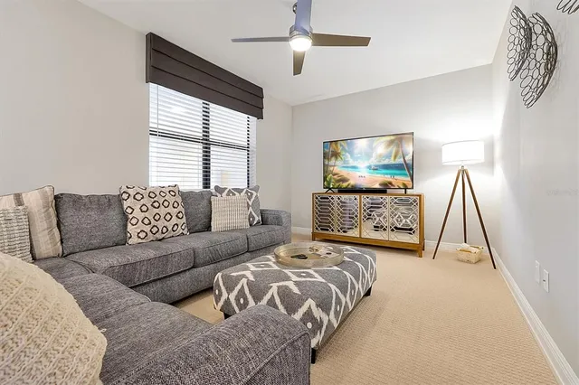 a spacious bedroom with a bed and a flat screen tv