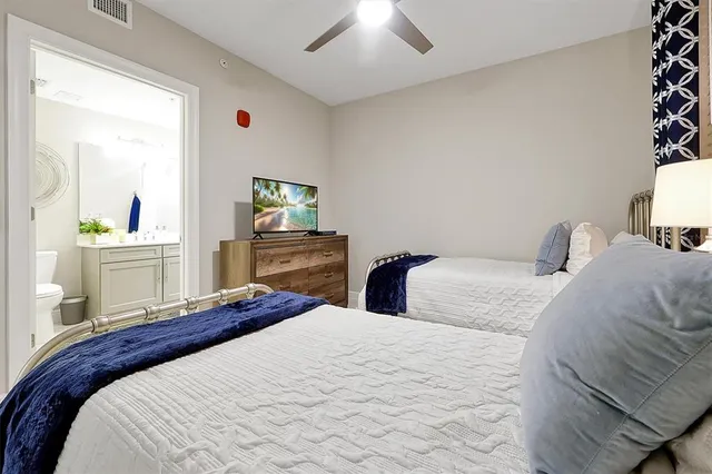 a bedroom with a bed and a desk