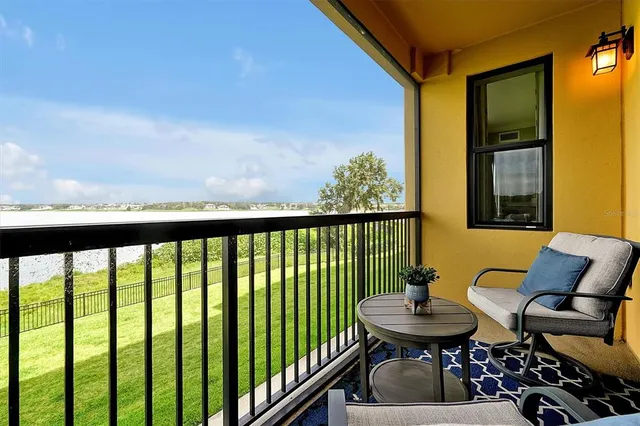 a view of a balcony with furniture and a floor to ceiling window