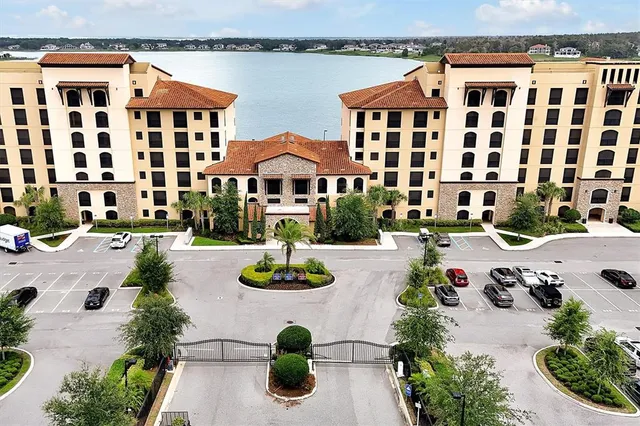 a view of a swimming pool with outdoor seating and plants
