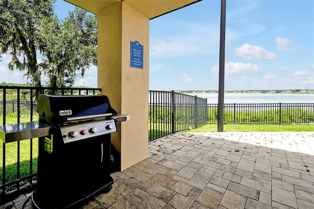 a view of backyard with barbeque grill and outdoor seating