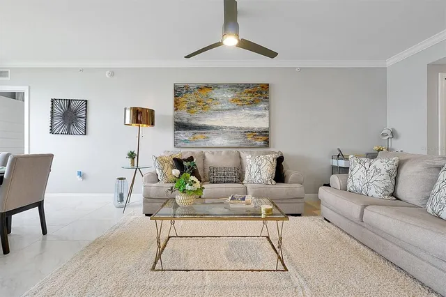 a living room with furniture and a chandelier