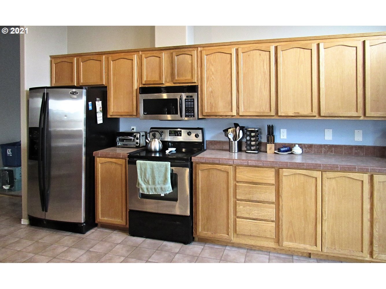 480 Roe Road Winlock, WA 98596 - Photo 5 of 24 a kitchen with stainless steel appliances granite countertop a refrigerator a stove a sink and white cabinets