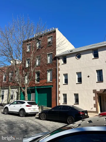 an aerial view of a backyard with table and chairs
