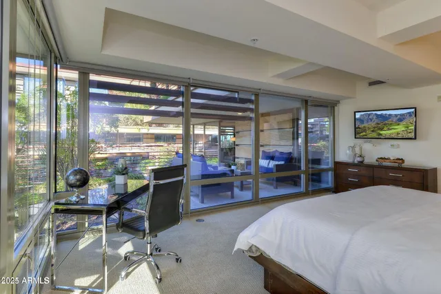 a bed room with a bed and a large window