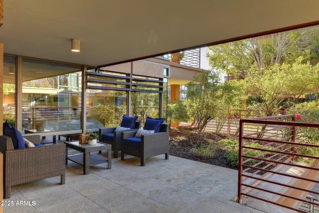 a living room with furniture and a floor to ceiling window
