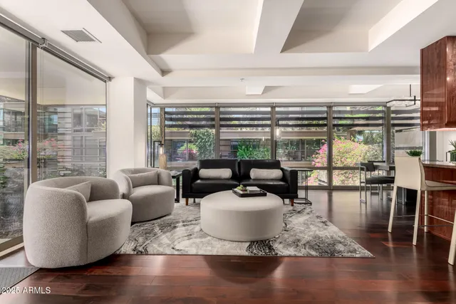 a living room with furniture and a floor to ceiling window