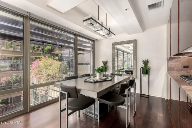 a view of a dining room with furniture window and wooden floor