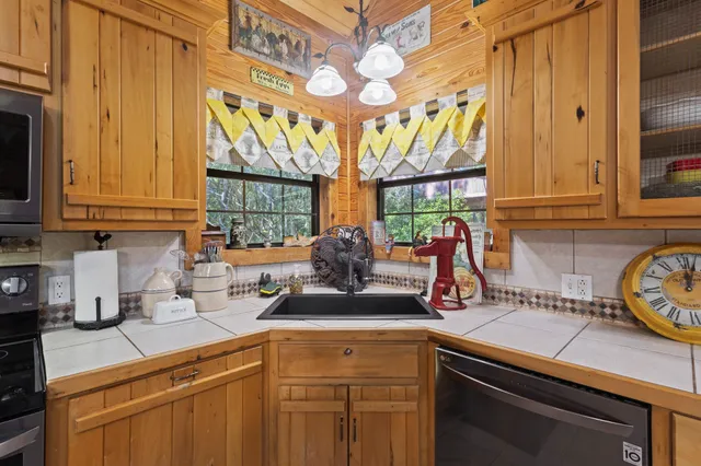 a kitchen with stainless steel appliances granite countertop a sink and a cabinets