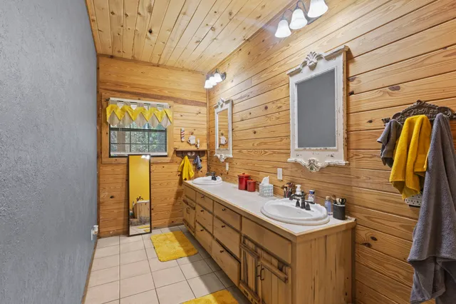 a bathroom with a sink a toilet and shower curtain