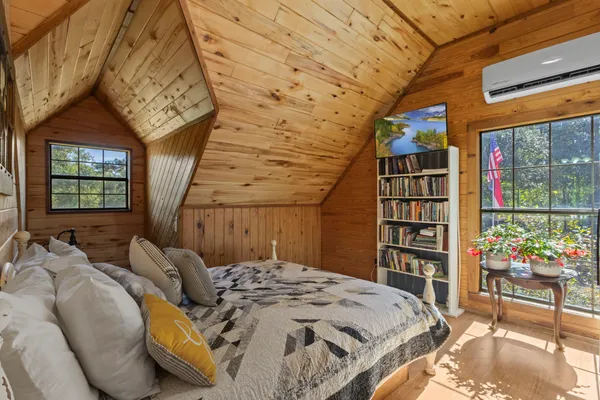 a bedroom with a bed and a book shelf