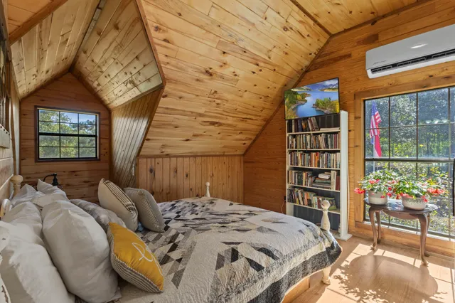 a bedroom with a bed and a book shelf