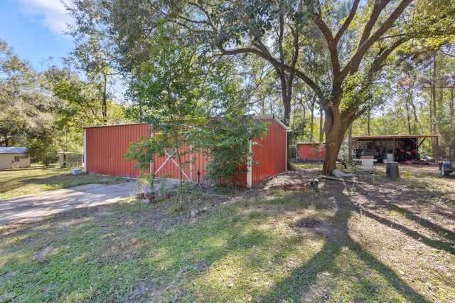 a view of a car parked in back yard of the house