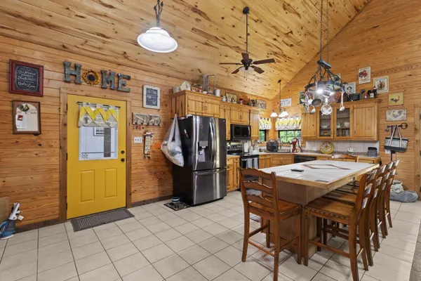 a kitchen with stainless steel appliances granite countertop a refrigerator and a stove top oven