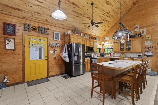 a kitchen with stainless steel appliances granite countertop a refrigerator and a stove top oven