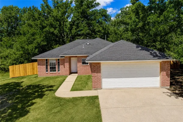 a house with trees in the background