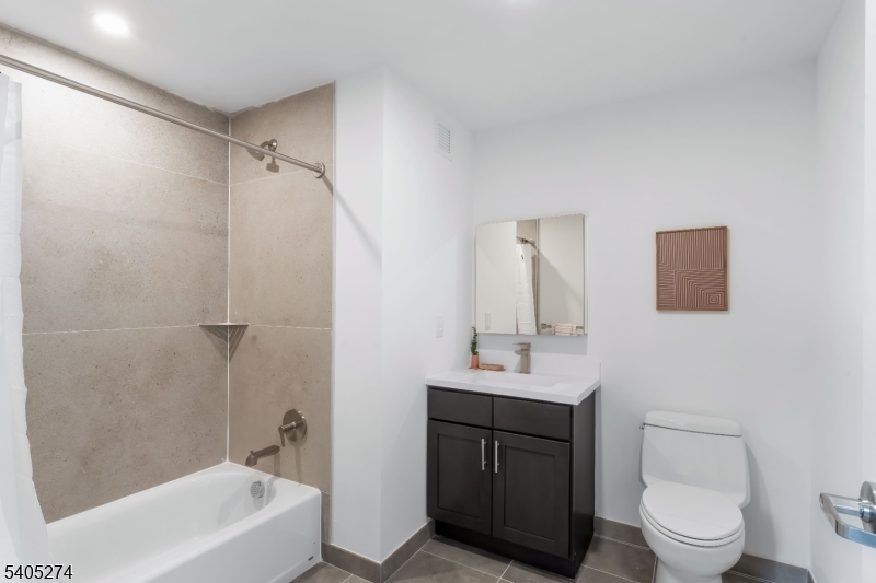 10 Commerce Court, Unit 5G Newark, NJ 07102 - Photo 11 of 11 a bathroom with a sink a toilet and shower