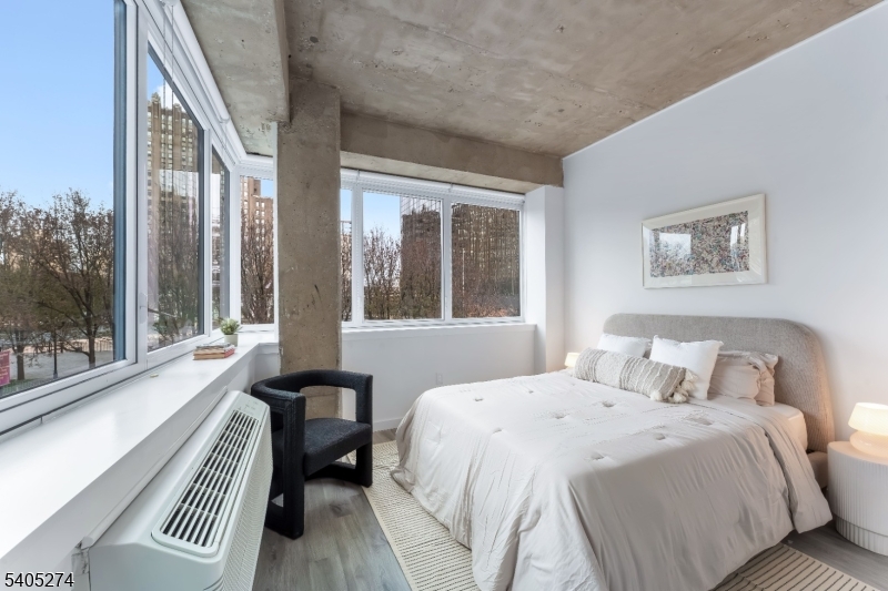 10 Commerce Court, Unit 5G Newark, NJ 07102 - Photo 9 of 11 a bedroom with a large bed and a large window