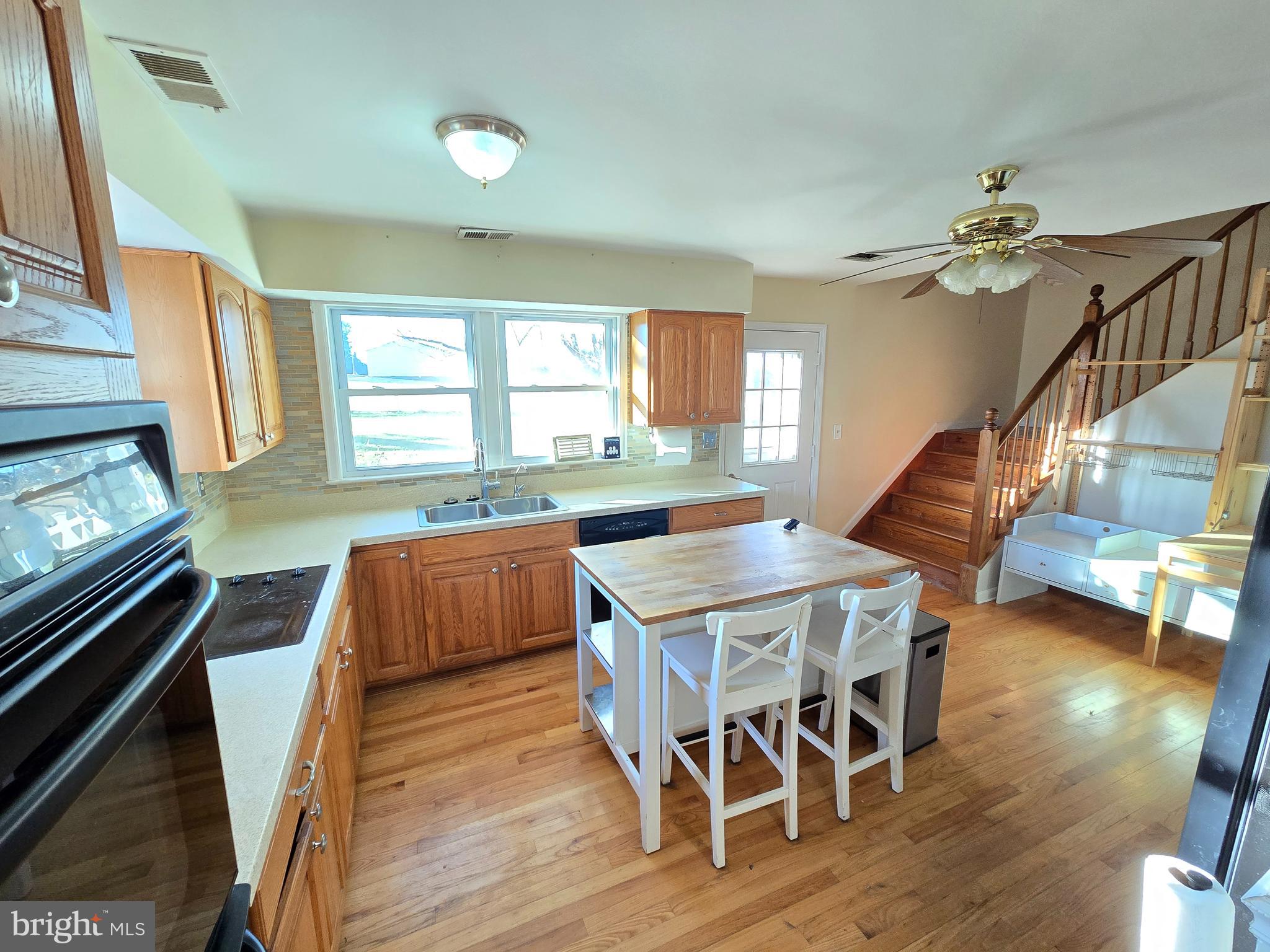 2621 Braddock Road Mount Airy, MD 21771 - Photo 8 of 15 a dining room with wooden floor a chandelier a wooden table and chairs