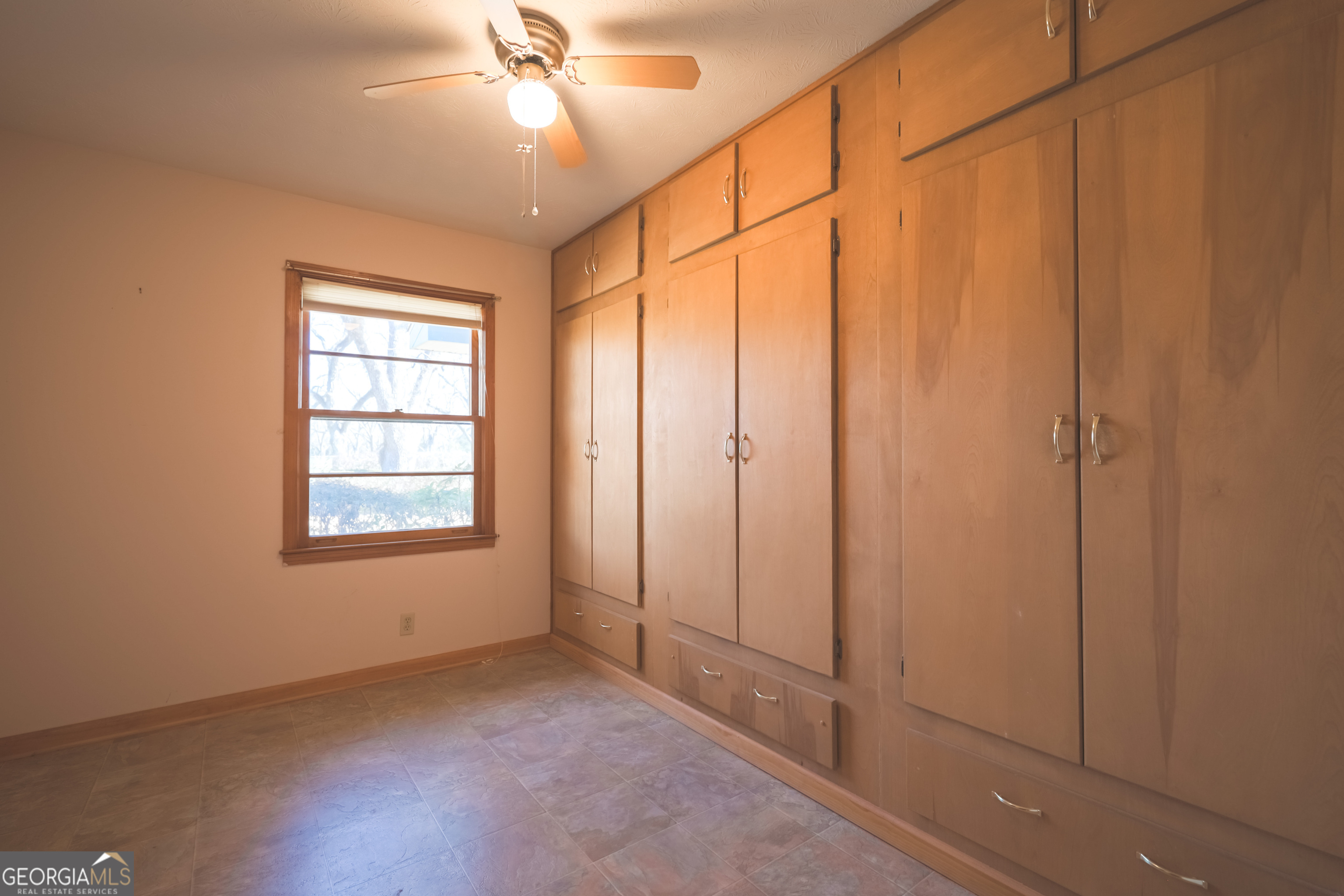 3111 Spatola Loop Blackshear, GA 31516 - Photo 16 of 23 an empty room with chandelier fan and windows
