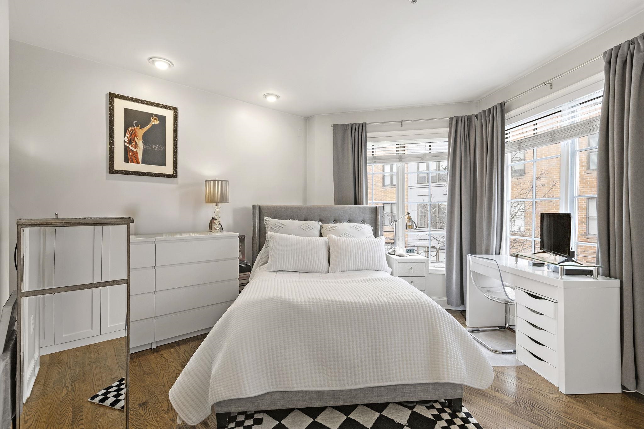 501 9th Street, Unit 309 Hoboken, NJ 07030 - Photo 11 of 18 a bedroom with a large bed and a window