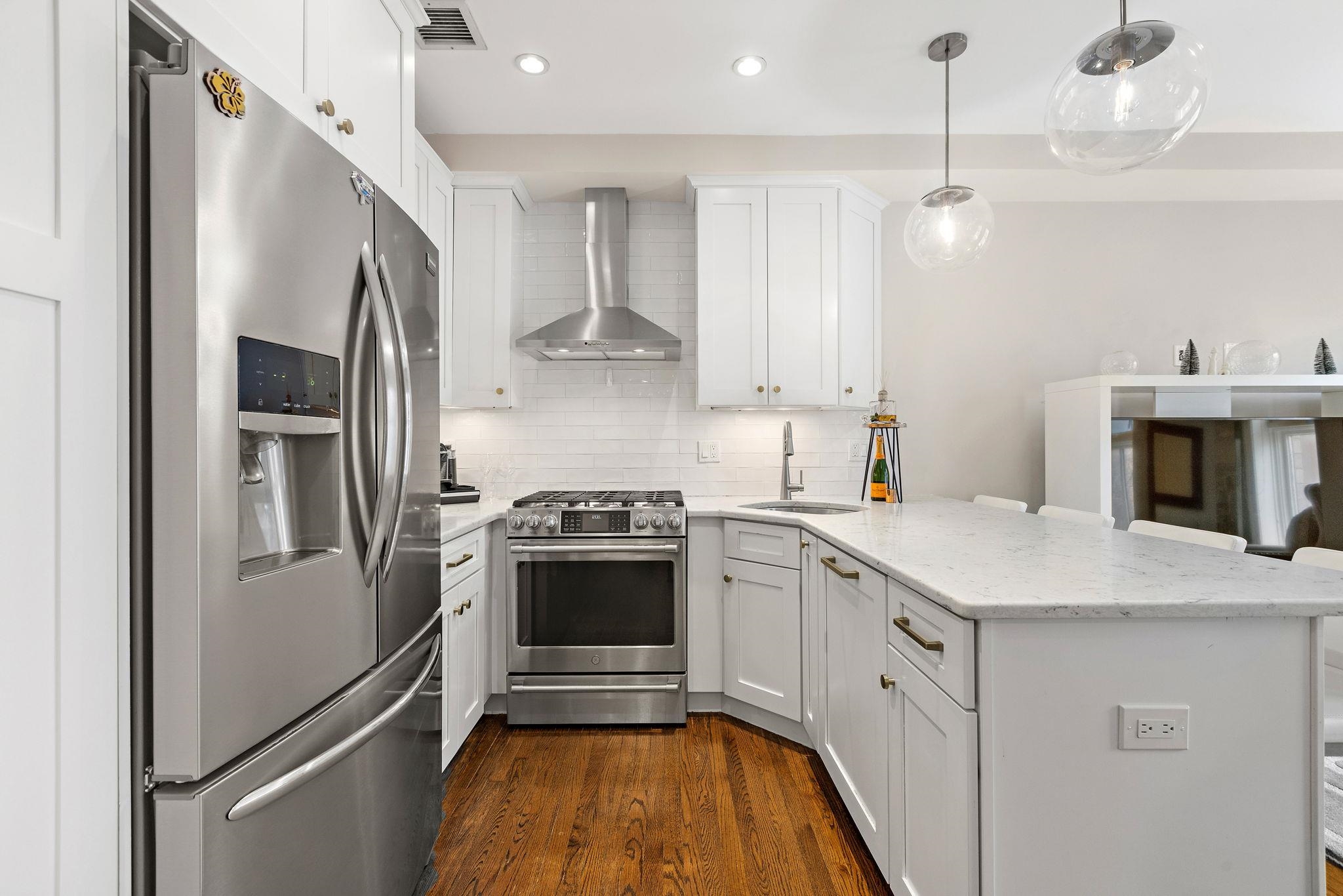 501 9th Street, Unit 309 Hoboken, NJ 07030 - Photo 2 of 18 a kitchen with stainless steel appliances a refrigerator sink and stove